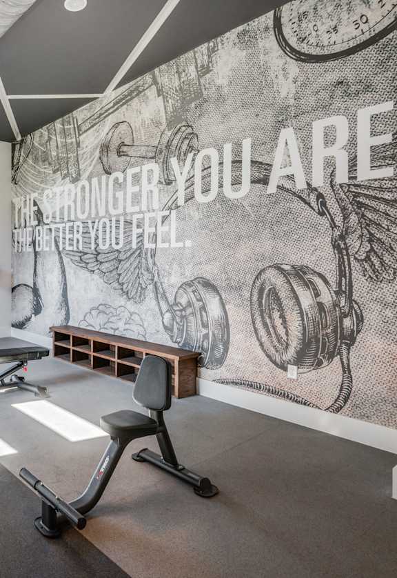 A gym with a motivational poster on the wall.