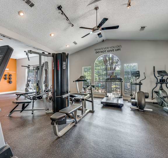 a workout room with red walls and exercise equipment