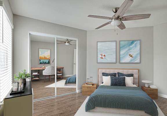 A bedroom with a bed, a desk, a chair, a ceiling fan, and two framed pictures on the wall.