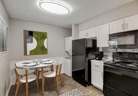 a kitchen and dining area in a 555 waverly unit
