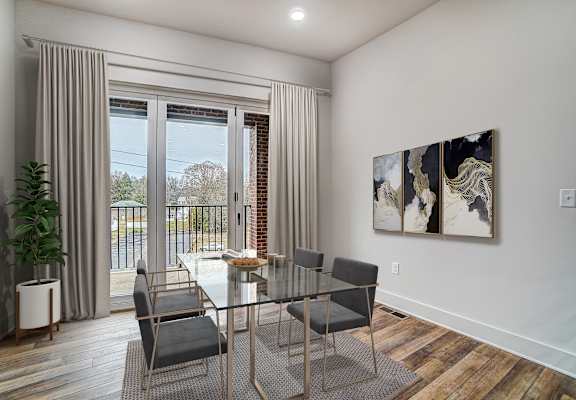 a dining room with a glass table and chairs