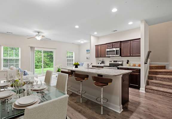 a kitchen and dining area with a table and chairs