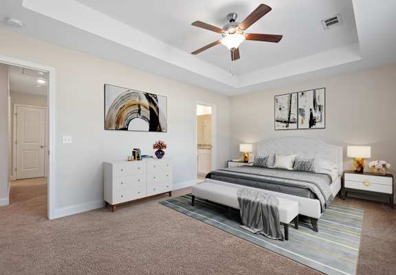 a bedroom with a bed and a ceiling fan