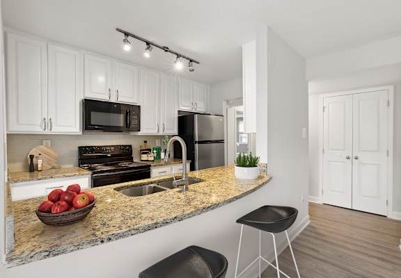 a kitchen with white cabinets and a granite counter top and a sink at Ellicott Grove, Ellicott City, MD 21043