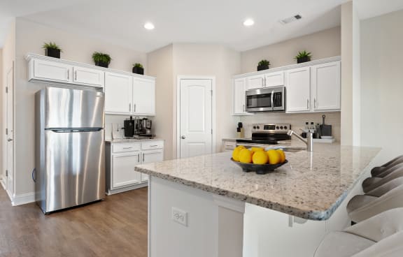 a kitchen with stainless steel appliances and a granite counter top