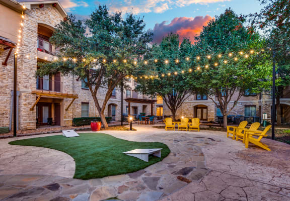 the courtyard at our apartments is decorated with lights and grass