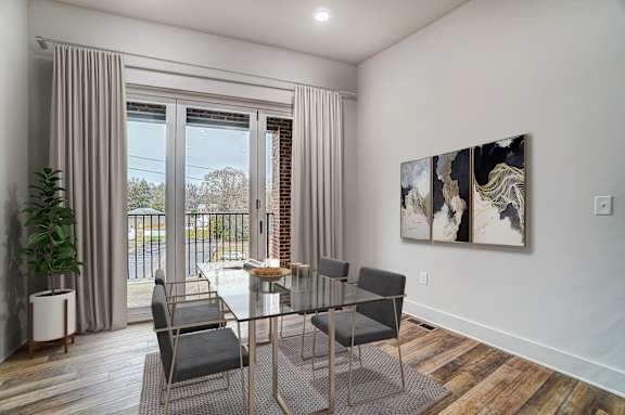 a dining room with a glass table and chairs