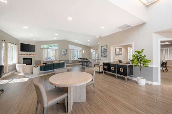 A modern kitchen with a stainless steel refrigerator and grey cabinets.