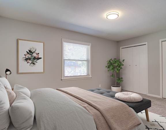 a bedroom with a large bed and two closets