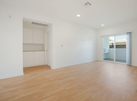 A bedroom with a large bed and two picture frames on the wall at Valley Street Apartment, Los Angeles, CA, 90057