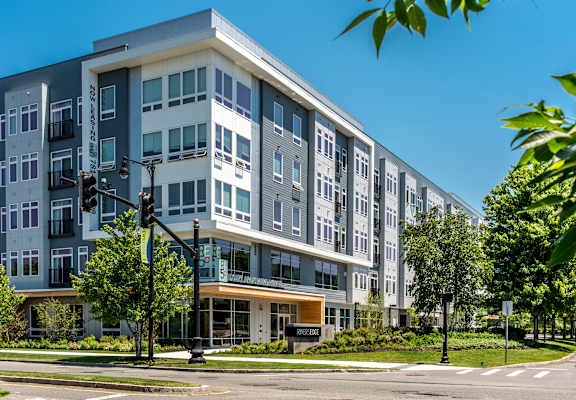 A modern multi-story building with a mix of grey and white exterior.