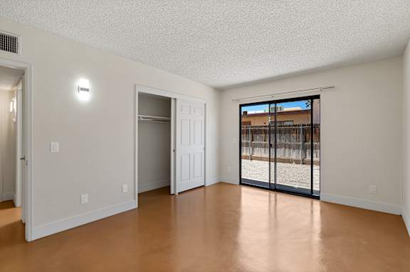 A room with a sliding glass door leading to a balcony at San Xavier Casitas, Arizona, 85716