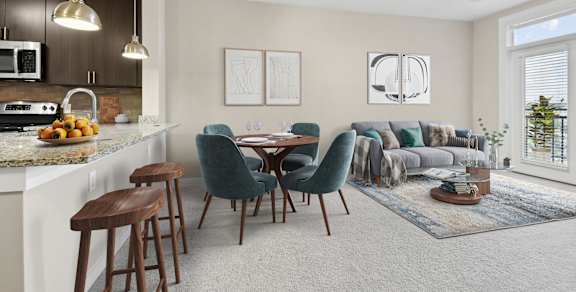 A modern kitchen with a dining area and a living room.