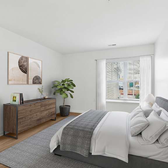 A bedroom with a large bed and a wooden dresser.