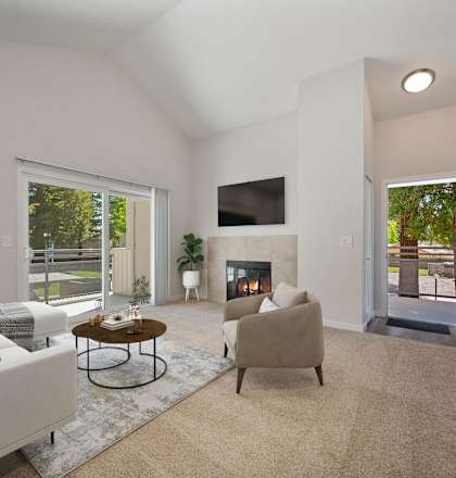 a living room with a couch and a chair and a fireplace at Rush River Apartments, California