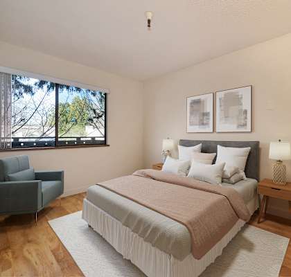 a bedroom with a large bed and a window