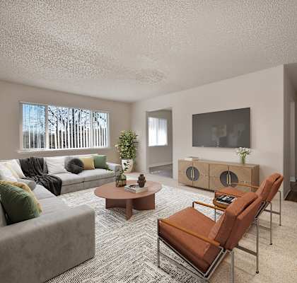 the living room of an apartment with a couch and chairs