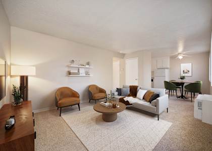 A living room with a couch, chairs, and a coffee table.