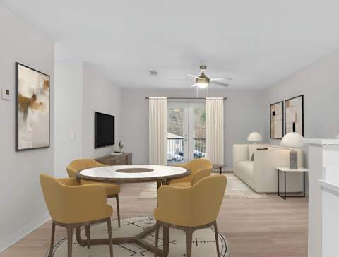 A modern dining room with a round table and yellow chairs at Grand at Pearl Apartments, Pearl, MS