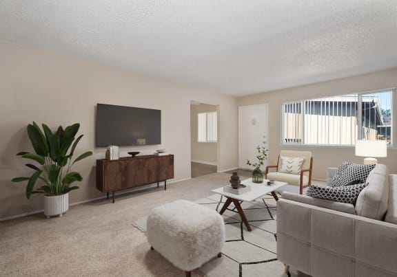 a living room with a couch and a chair and a television