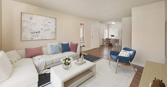 a living room with a white couch and a coffee table at Fountains of Fair Oaks, Fair Oaks