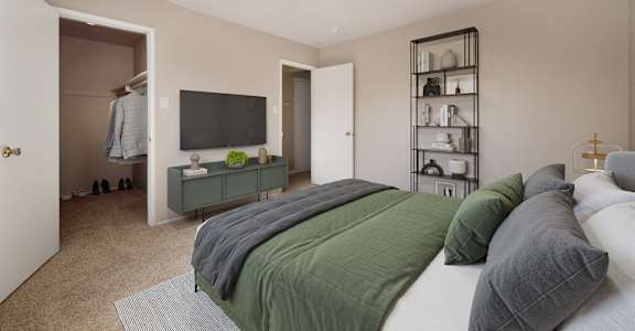 A bedroom with a bed, a television, and a shelf with various items.