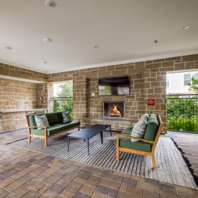 a resident clubhouse with a fire place and lounge chairs
