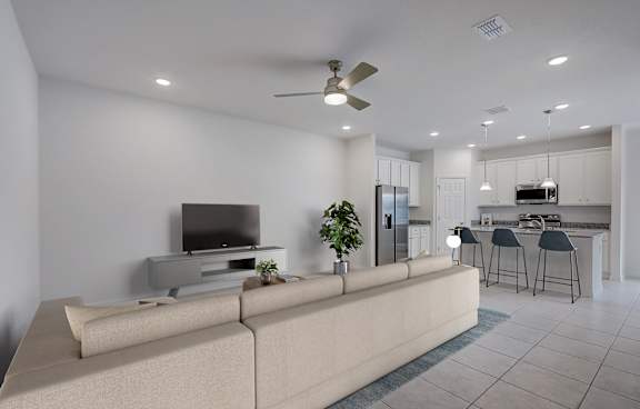 A modern living room with a large couch and a television.