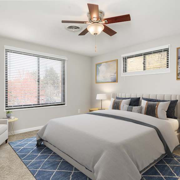 a bedroom with a large bed and a ceiling fan