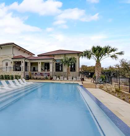 a house with a swimming pool in front of it