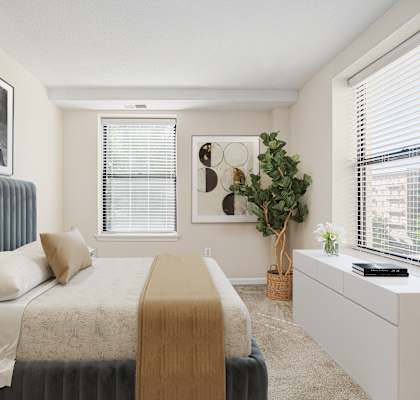A bedroom with a bed, a dresser, and a window with blinds. at Columbia Uptown Apartments, Washington, 20009