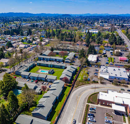 A bird's eye view of a small town with a road running through the center.