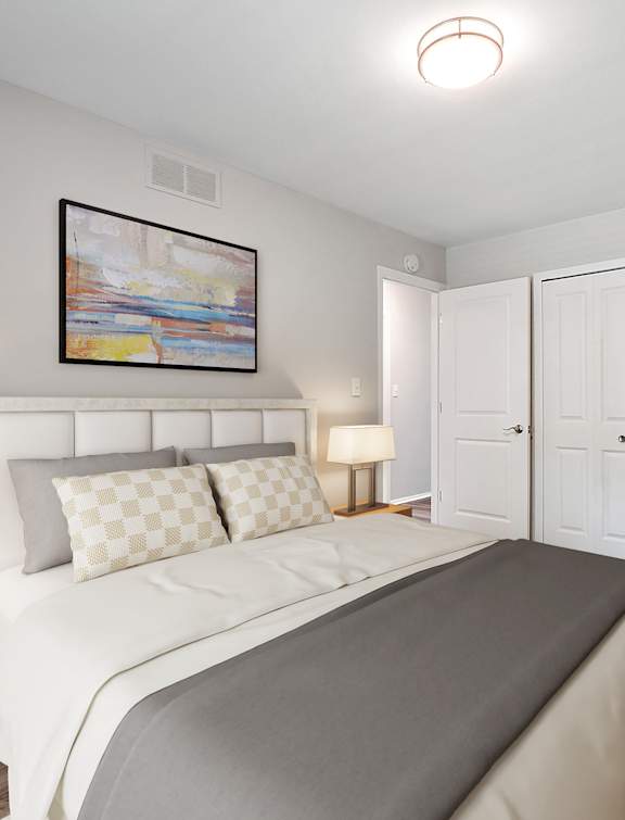 A bedroom with a large bed and a painting above it.