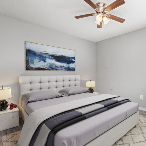 a bedroom with a large bed and a ceiling fan