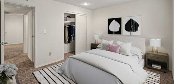 A bedroom with a large bed and a wardrobe.