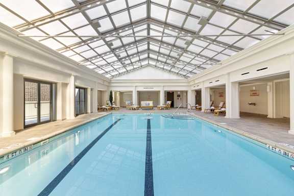 a swimming pool under a glass ceiling under a large skylight at HIGHGROVE, Stamford, Connecticut