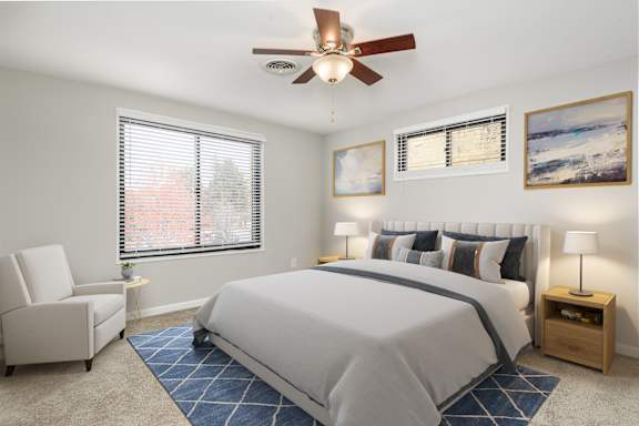 a bedroom with a large bed and a ceiling fan
