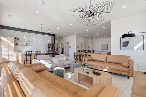 A modern living room with a large sectional sofa and a coffee table.