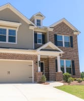 a house with a garage door in front of it