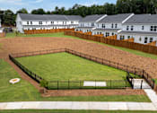 Thumbnail 3 of 6 - A black fenced in yard with a white house in the background.