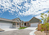 Thumbnail 5 of 8 - a house with two garage doors and a driveway