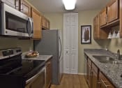 Thumbnail 6 of 17 - Renovated kitchen with granite counters, vinyl flooring and new cabinets