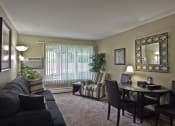 Thumbnail 2 of 17 - Furnished living room with wall decor, table, and chairs