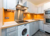 Thumbnail 4 of 5 - a kitchen with a washing machine and a sink
