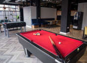 Thumbnail 8 of 8 - a red pool table in a room with other tables and chairs
