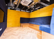 Thumbnail 2 of 8 - a room with a yellow wall and a blue couch