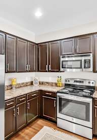 a kitchen with wooden cabinets and stainless steel appliances