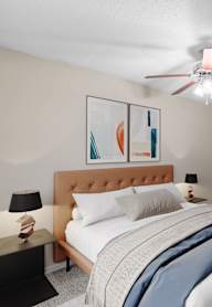 a bedroom with a large bed and two night stands with lamps