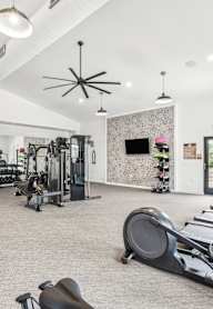 A gym with treadmills, weights, and exercise equipment.