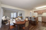 a kitchen and dining area with hardwood-style flooring and wood cabinetry